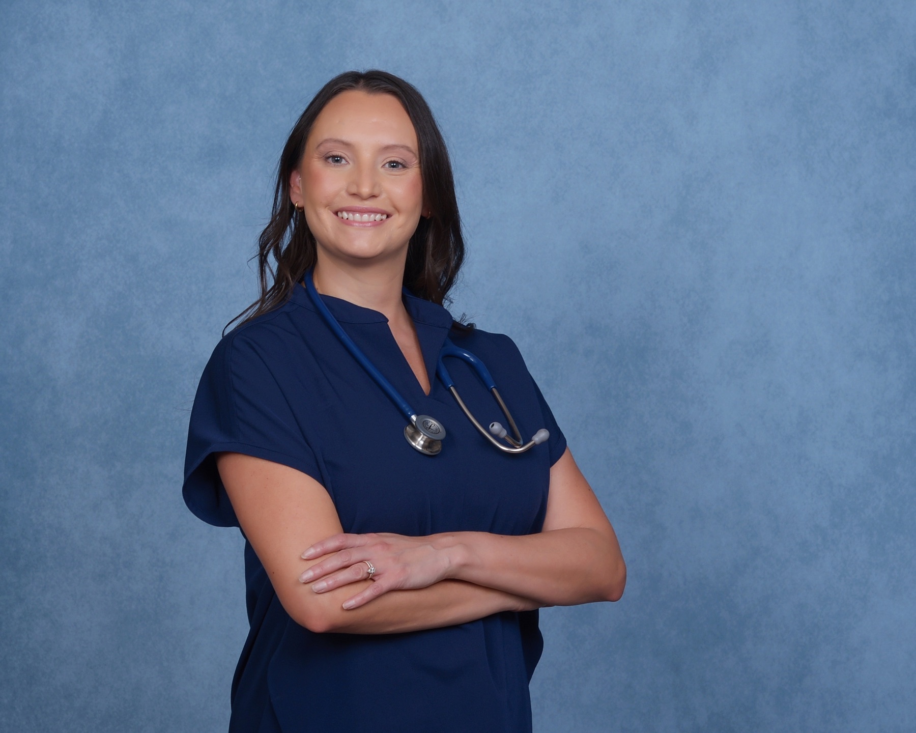 Regina Griego in nursing scrubs with a stethoscope